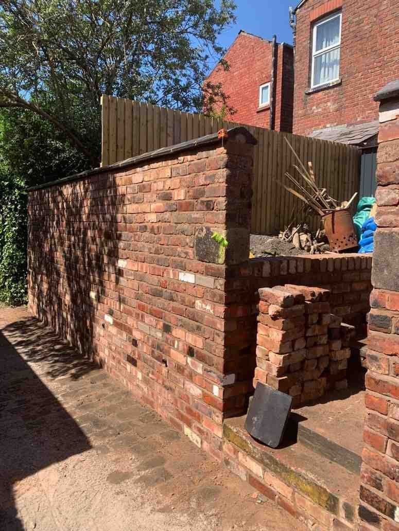 Old brick boundary wall rebuilt and repointed by AJ Brickwork in Manchester